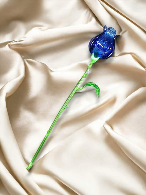 a blue flower sitting on top of a white sheet