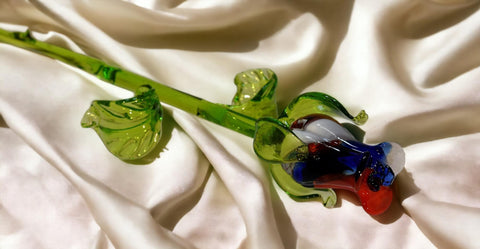 a glass flower on a white cloth