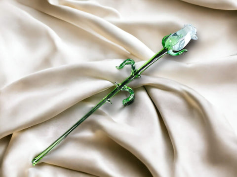 a flower that is laying on a white cloth